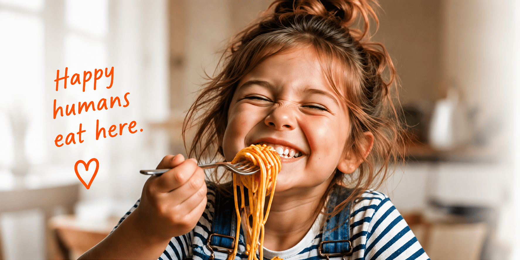 A child laughing with a forkful of spaghetti. Happy humans eat here.